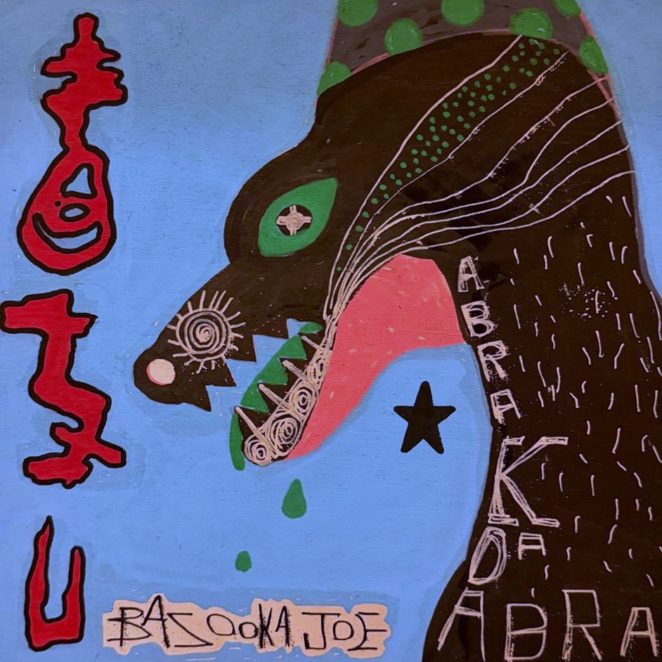 Abrakadabra by Bazooka Joe. A dark beast with a green eye and open pink jaws on sky blue, red glyphs down the left edge
