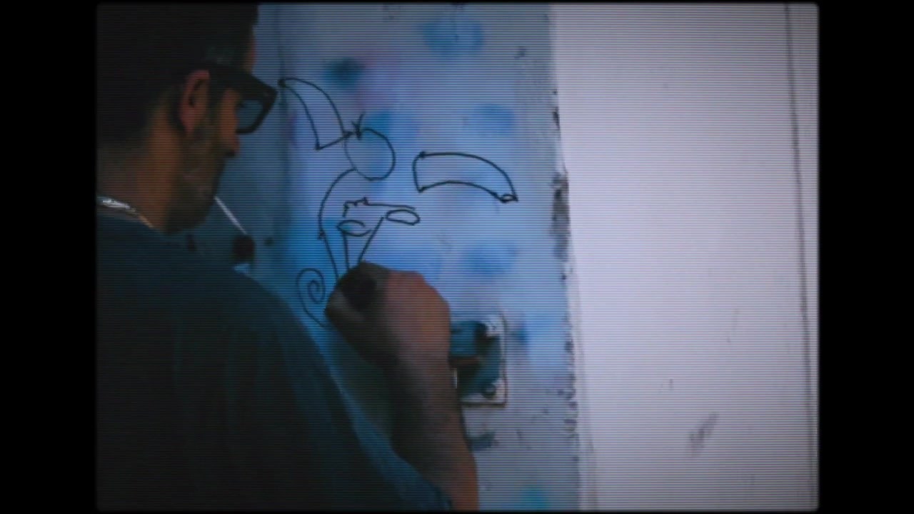 Bazooka Joe drawing a figure straight onto a studio wall