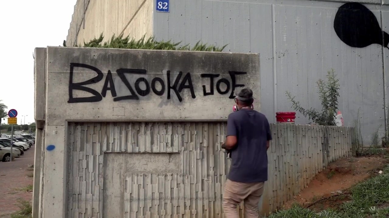 Bazooka Joe painting his name in large letters on the wall