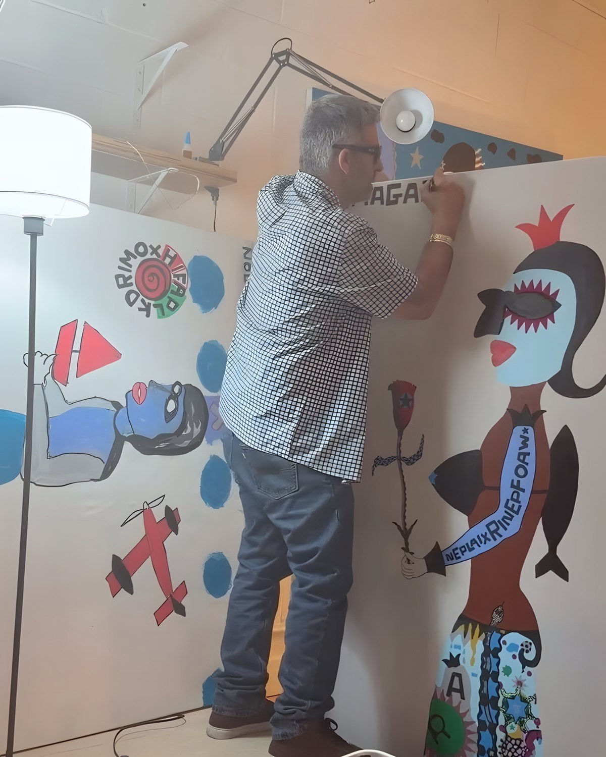 Bazooka Joe, Gangster of Art, lettering a wall-size figure in the studio