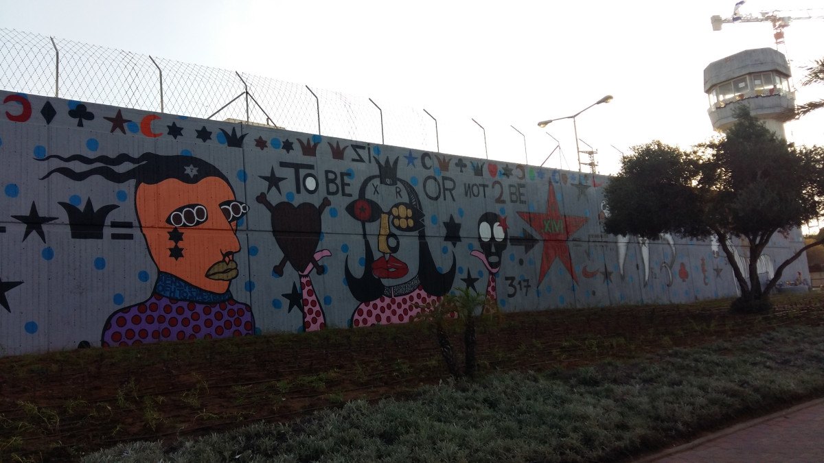 Walls of Hope by Bazooka Joe. The painted outer wall of the prison, watchtower behind